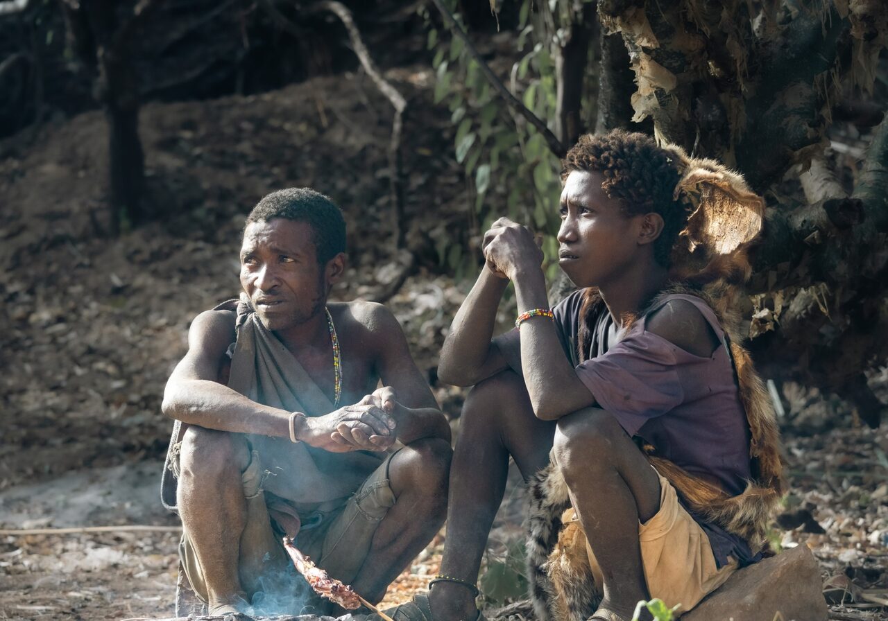 Hadzabe men making fire by hand at their camp